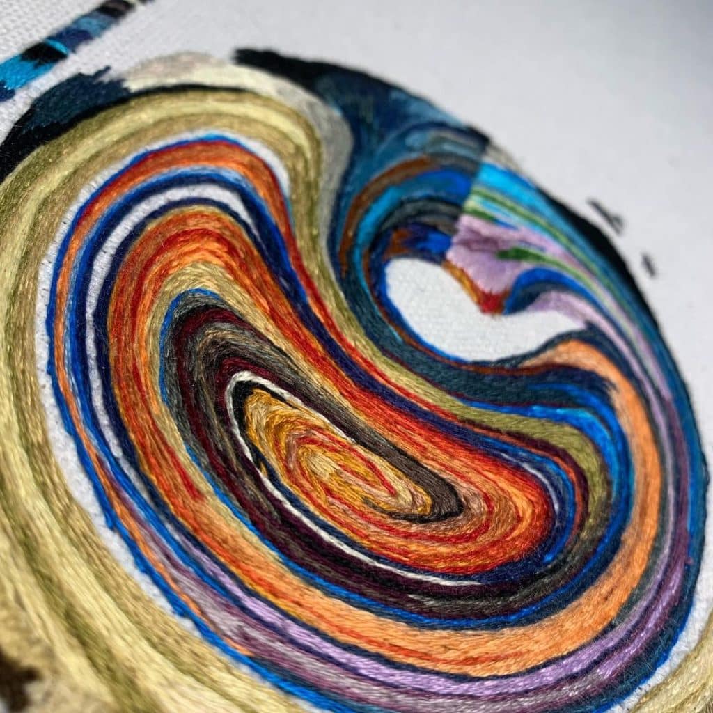 colorful swirls embroidered on canvas